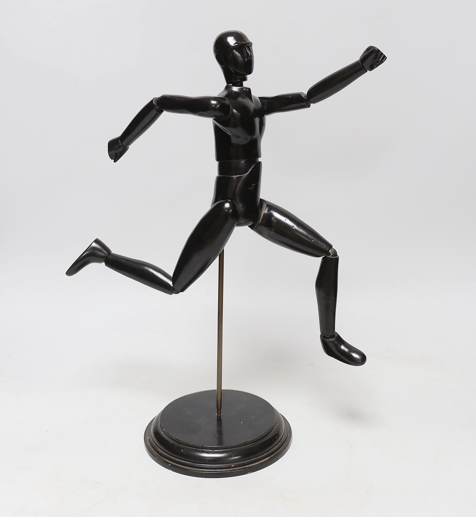 A carved wood lay figure on stand, 38cm